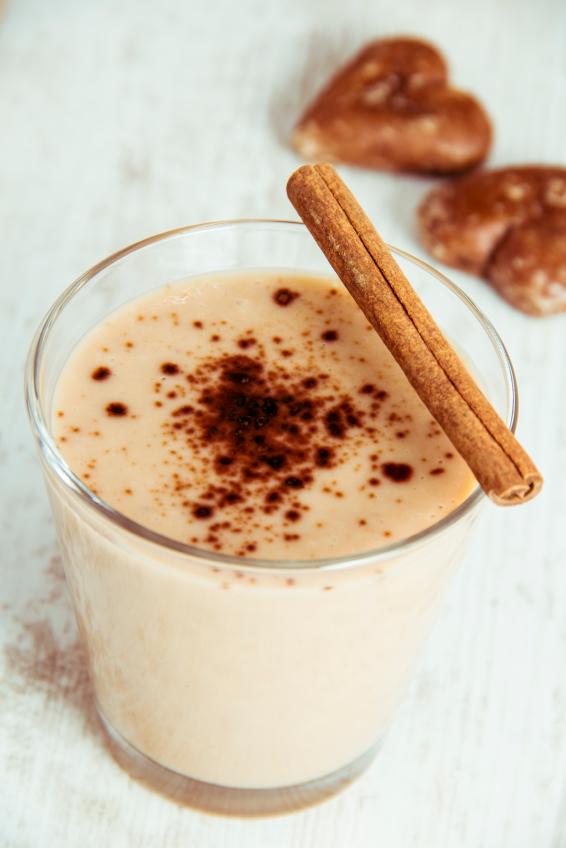 Delicious Milkshake with cinnamon and Cookies on Wooden Table